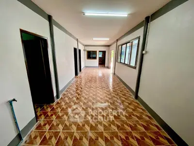 Spacious hallway with patterned tile flooring and multiple doorways in a modern home.