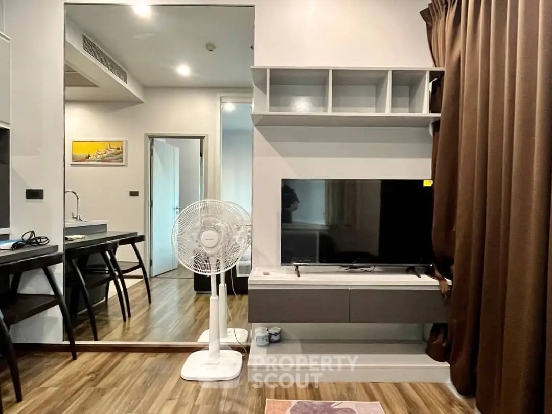 Modern living room with sleek TV unit and stylish decor in a cozy apartment.