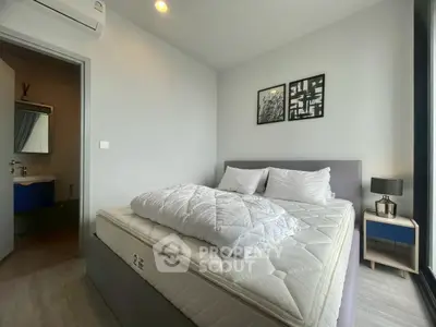 Modern bedroom with cozy bed and stylish decor in a contemporary apartment.
