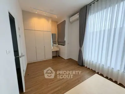 Spacious bedroom with modern design and ample natural light