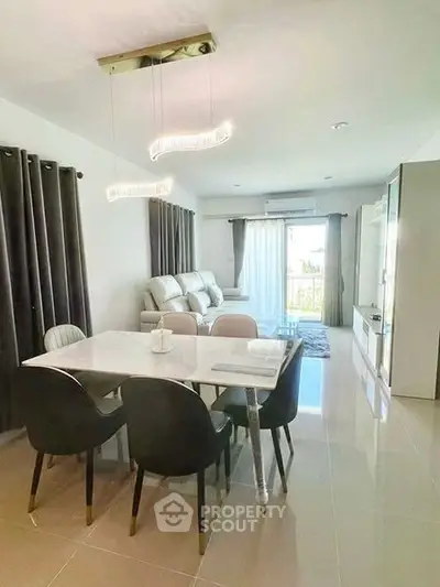 Modern living room with elegant dining area and stylish lighting fixtures.