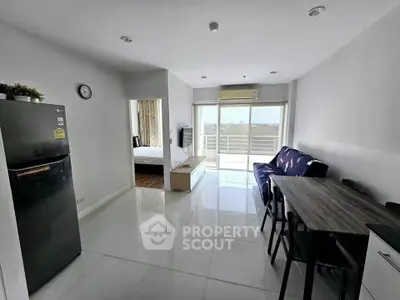 Modern open-plan living room with sleek furniture and balcony view