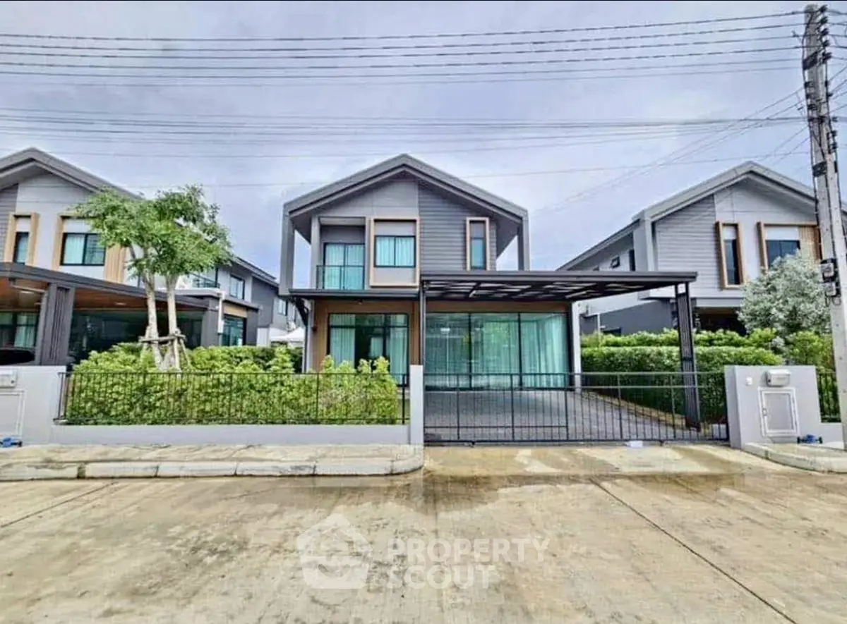 Modern suburban house with sleek design and spacious driveway in a serene neighborhood.