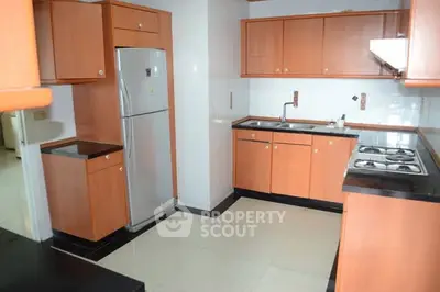 Spacious kitchen with wooden cabinets and modern appliances