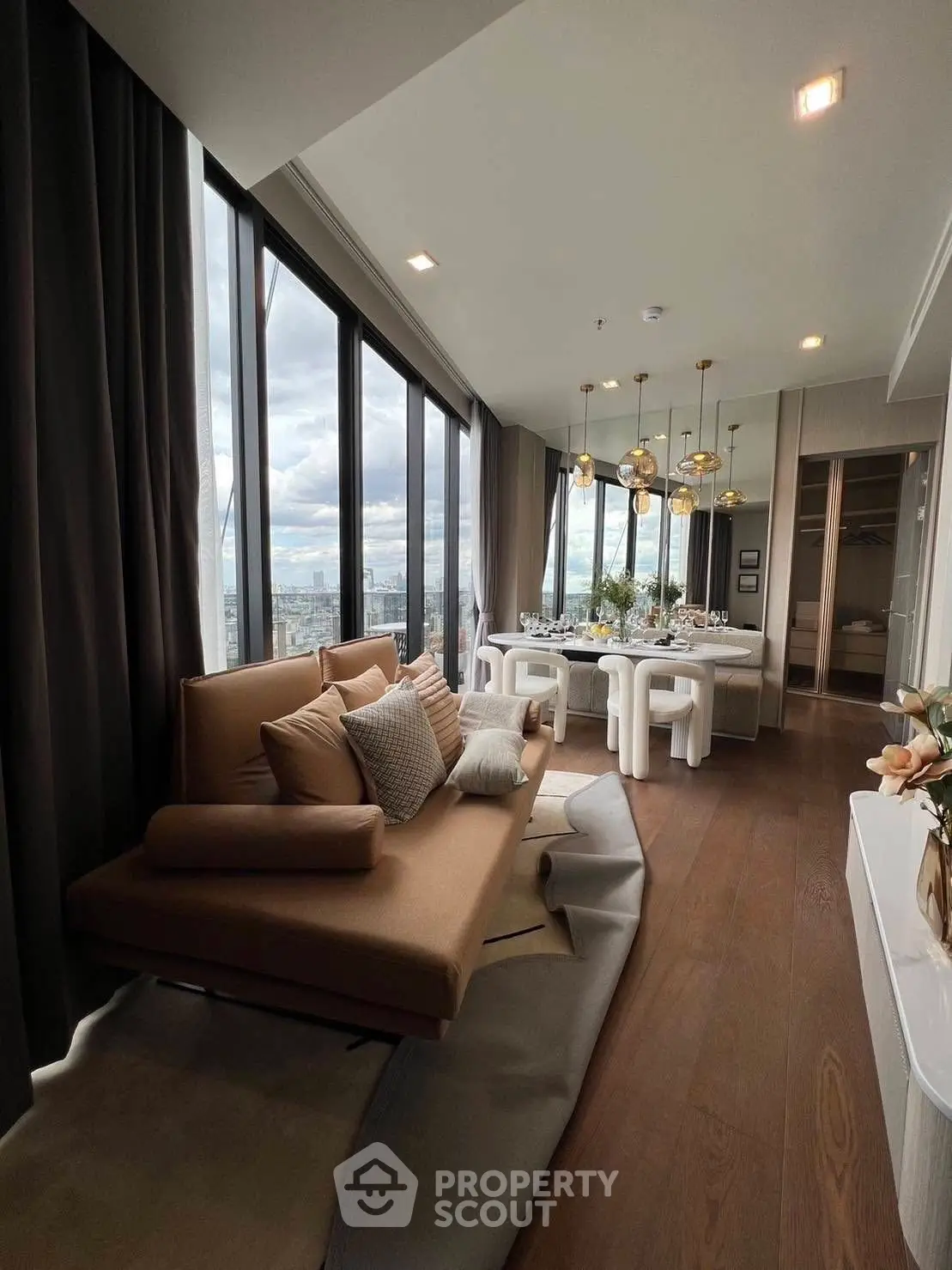 Luxurious living room with panoramic city views and elegant dining area