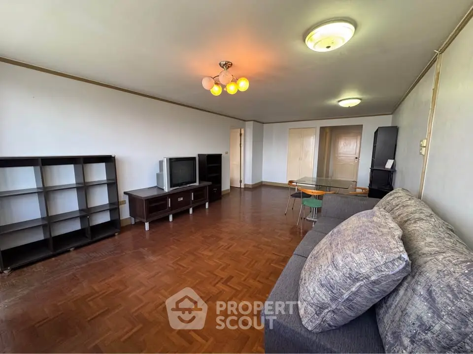 Spacious living room with parquet flooring and modern furniture