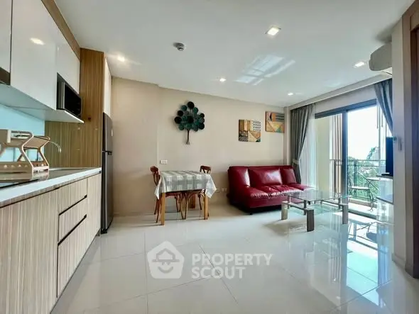 Modern living room with open kitchen and balcony view