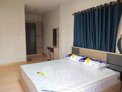 Spacious bedroom with modern furnishings and natural light