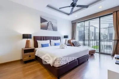 Spacious modern bedroom with large windows and stylish decor
