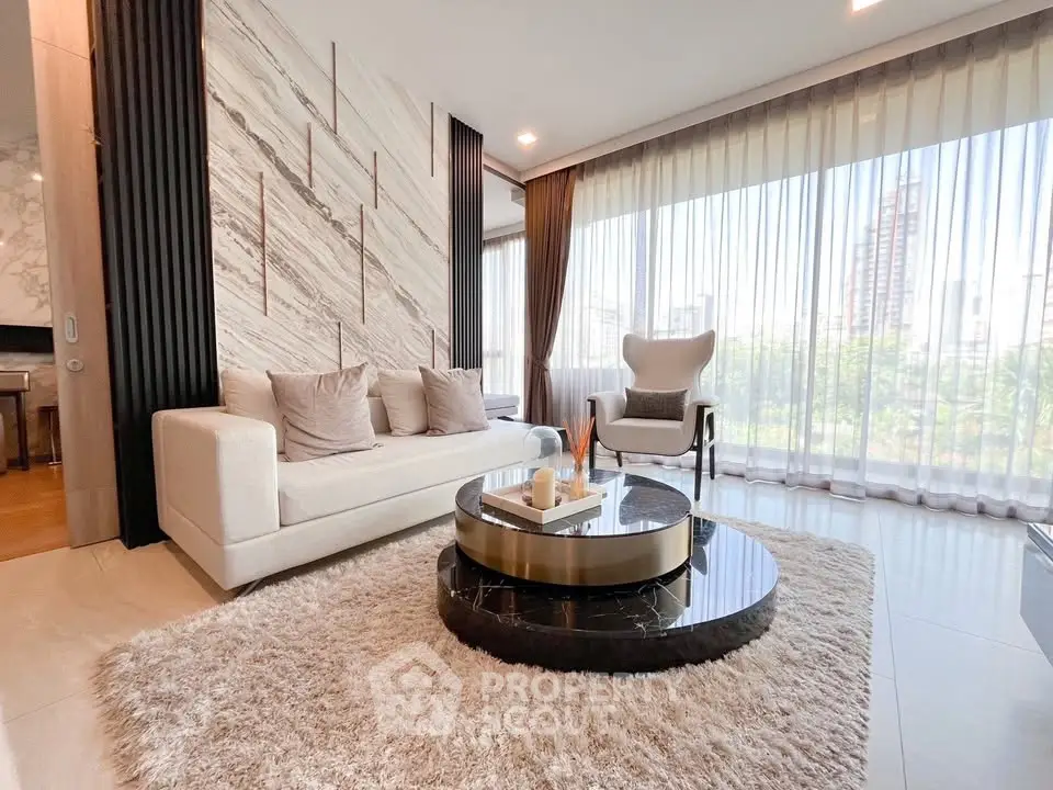 Luxurious living room with modern decor and floor-to-ceiling windows offering stunning city views.