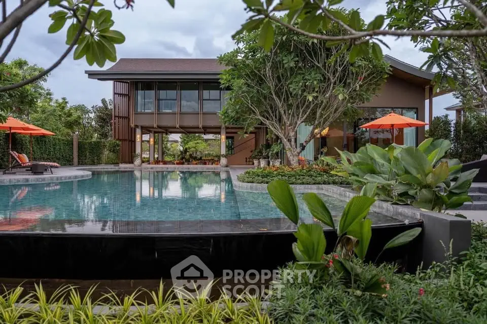 Luxurious villa with stunning pool and lush garden, perfect for relaxation and entertainment.