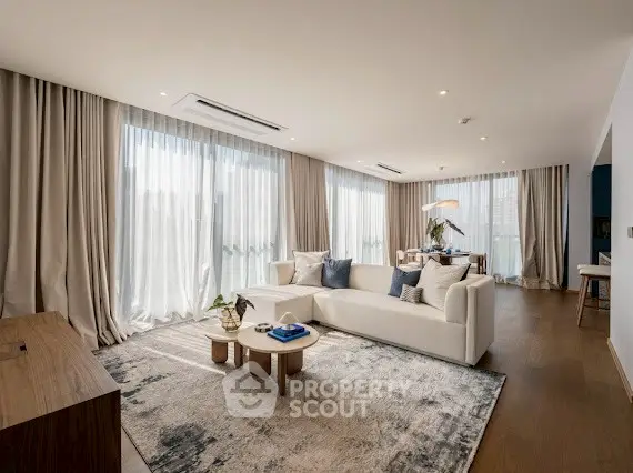 Luxurious living room with elegant decor and large windows offering abundant natural light.