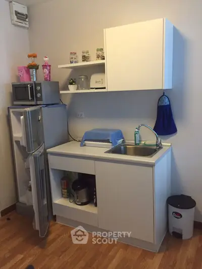 Compact kitchen with modern appliances and wooden flooring