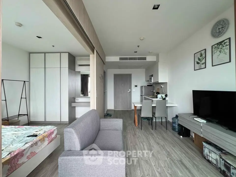 Modern studio apartment with open layout, featuring sleek furniture and stylish decor.