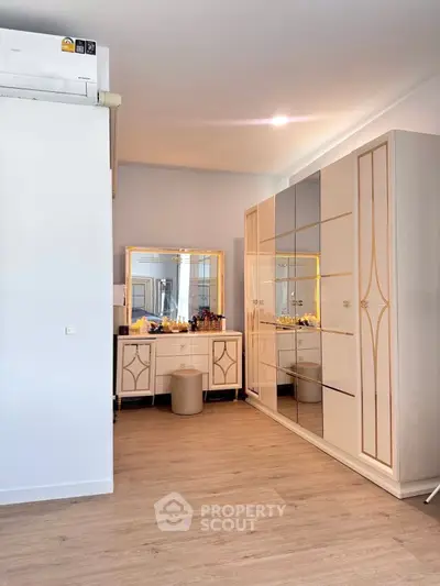 Elegant bedroom with stylish wardrobe and vanity in modern apartment