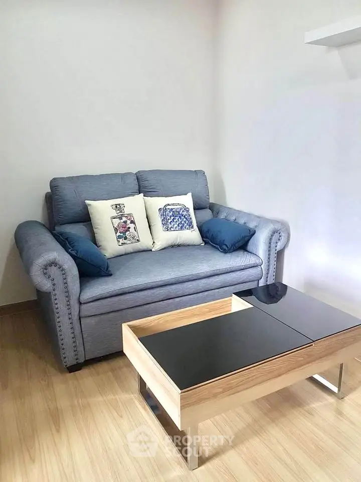 Cozy living room with stylish sofa and modern coffee table in a bright space.