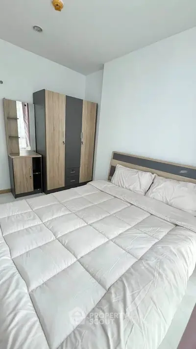 Modern bedroom with sleek wardrobe and cozy bed in minimalist design.