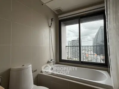 Modern bathroom with bathtub and city view from large window