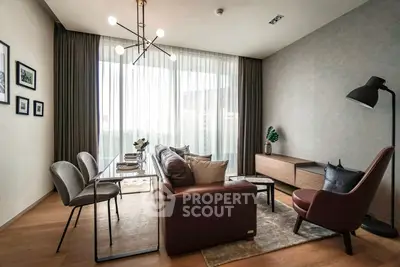 Modern living room with stylish furniture and large window, perfect for urban living.