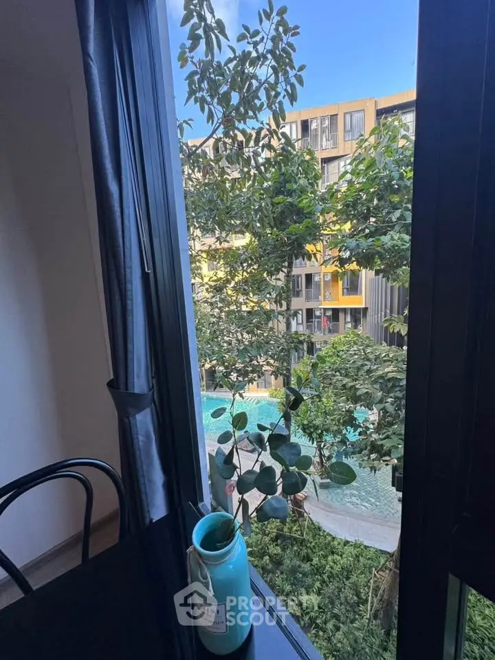 Stunning view from window overlooking lush garden and modern building