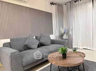 Modern living room with stylish gray sofa and elegant decor