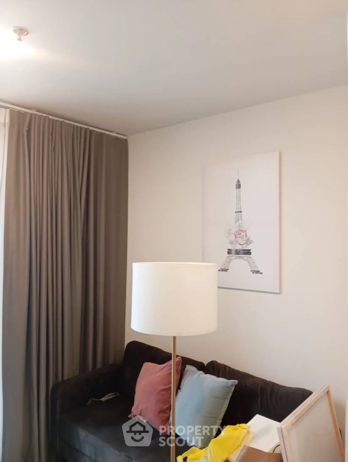 Cozy living room with elegant decor and Eiffel Tower artwork, perfect for relaxation.