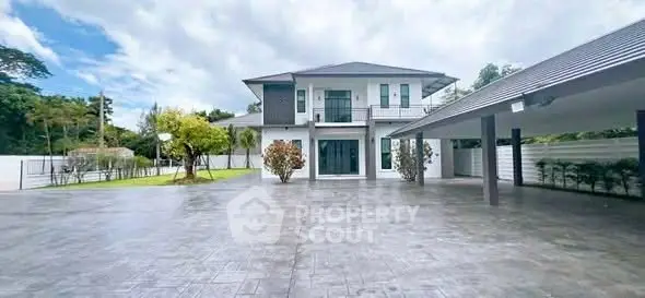 Stunning modern two-story house with spacious driveway and lush greenery, perfect for luxurious living.