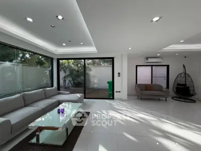 Spacious modern living room with large windows and sleek furniture