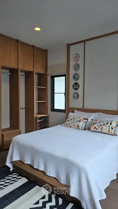 Charming bedroom with wooden accents and cozy decor, perfect for relaxation and comfort.