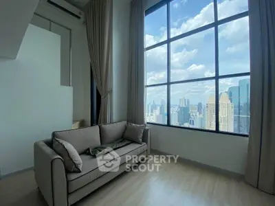 Spacious living room with stunning city view and modern sofa
