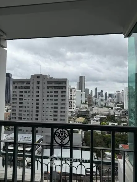 Stunning cityscape view from a high-rise balcony with elegant railing.