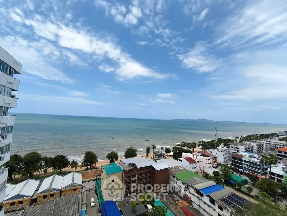 Stunning coastal view from high-rise building overlooking the ocean and cityscape.