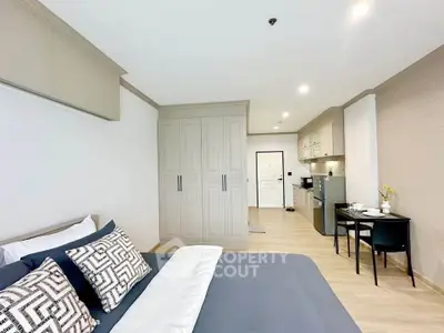 Modern studio apartment with stylish decor and open kitchen layout