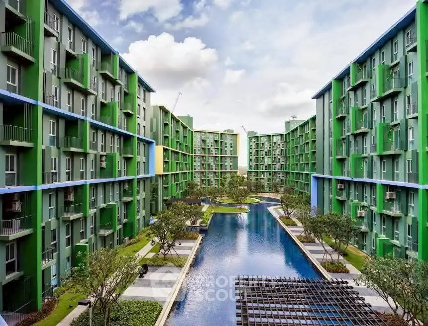 Stunning modern apartment complex with central pool and lush landscaping.