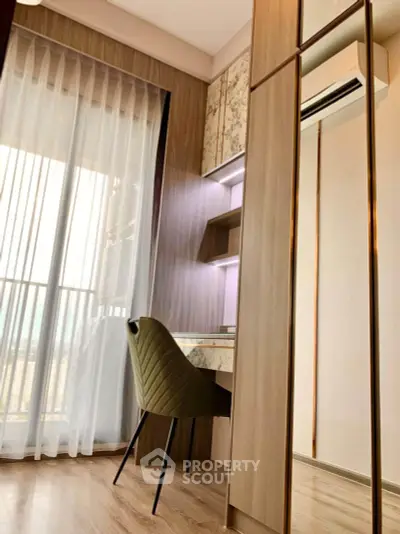Modern study area with elegant desk and chair, featuring floor-to-ceiling window and stylish decor.