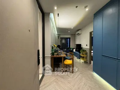 Modern living room with stylish decor and open layout, featuring a cozy dining area and sleek furniture.