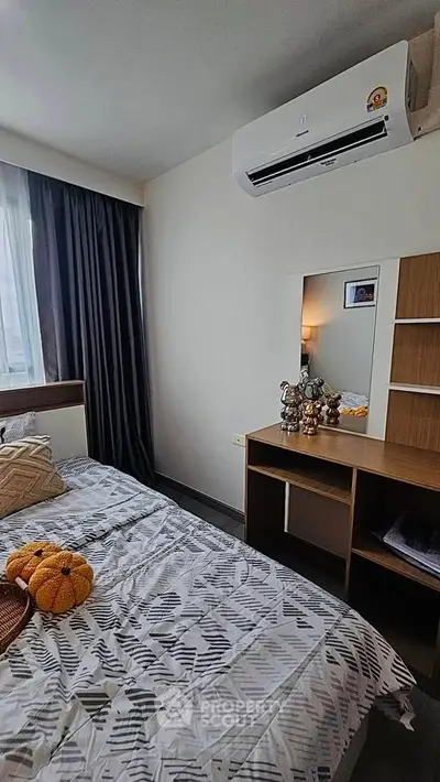 Cozy bedroom with modern decor and air conditioning, perfect for relaxation.