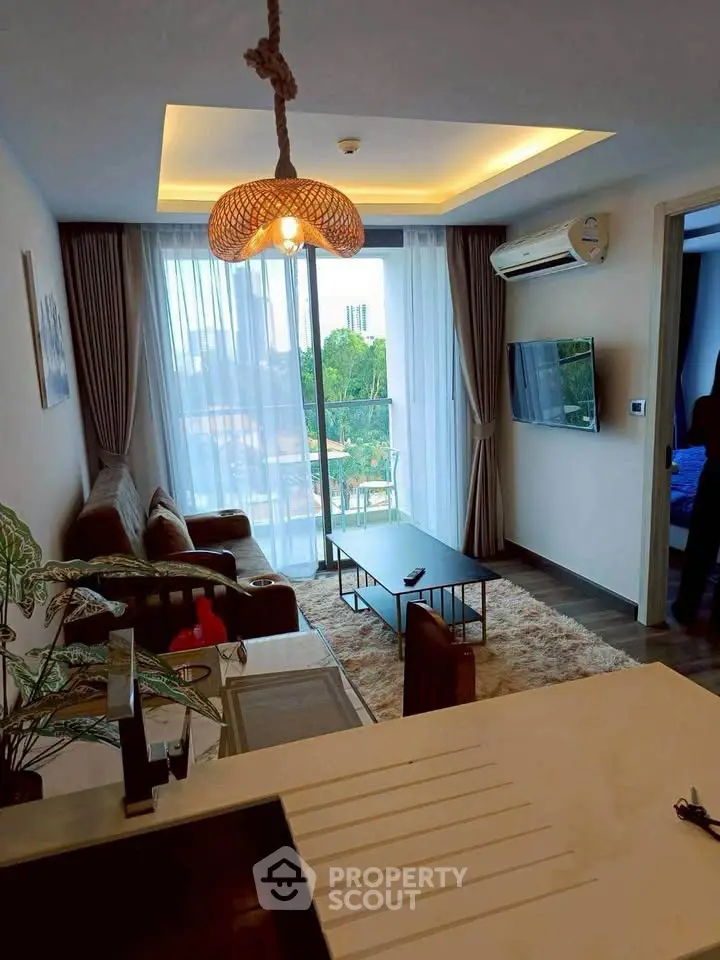 Modern living room with stylish decor, large window, and cozy seating area in a contemporary apartment.