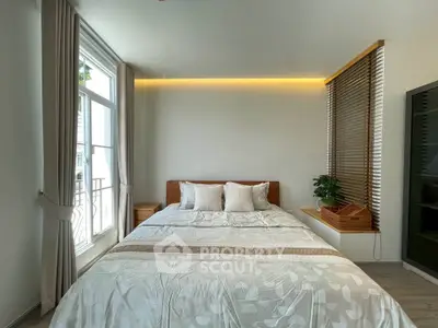 Modern bedroom with large window and stylish decor