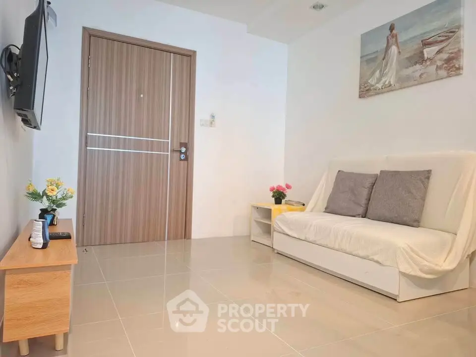 Modern living room with sleek design, featuring a cozy sofa, wall-mounted TV, and elegant decor.