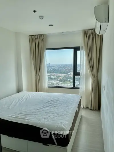 Modern bedroom with large window offering stunning city view