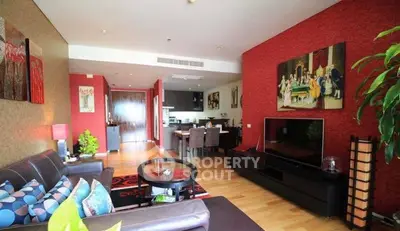 Spacious living room with modern decor and open kitchen layout