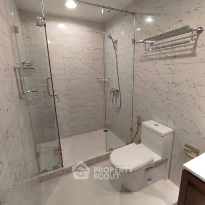 Modern bathroom with glass shower and sleek tile design