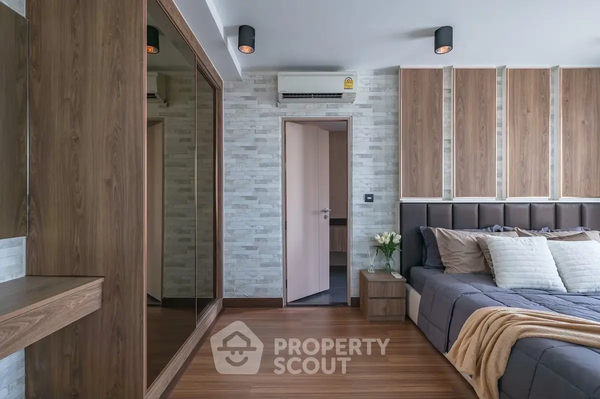 Luxurious bedroom with modern design, wooden flooring, and elegant decor