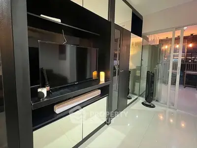 Modern living room with sleek black entertainment unit and ambient lighting
