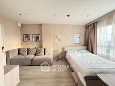 Modern studio apartment with cozy living area and large window view