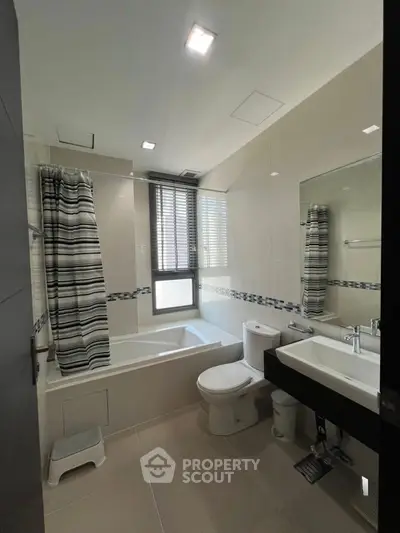 Modern bathroom with bathtub and stylish decor in a contemporary home.