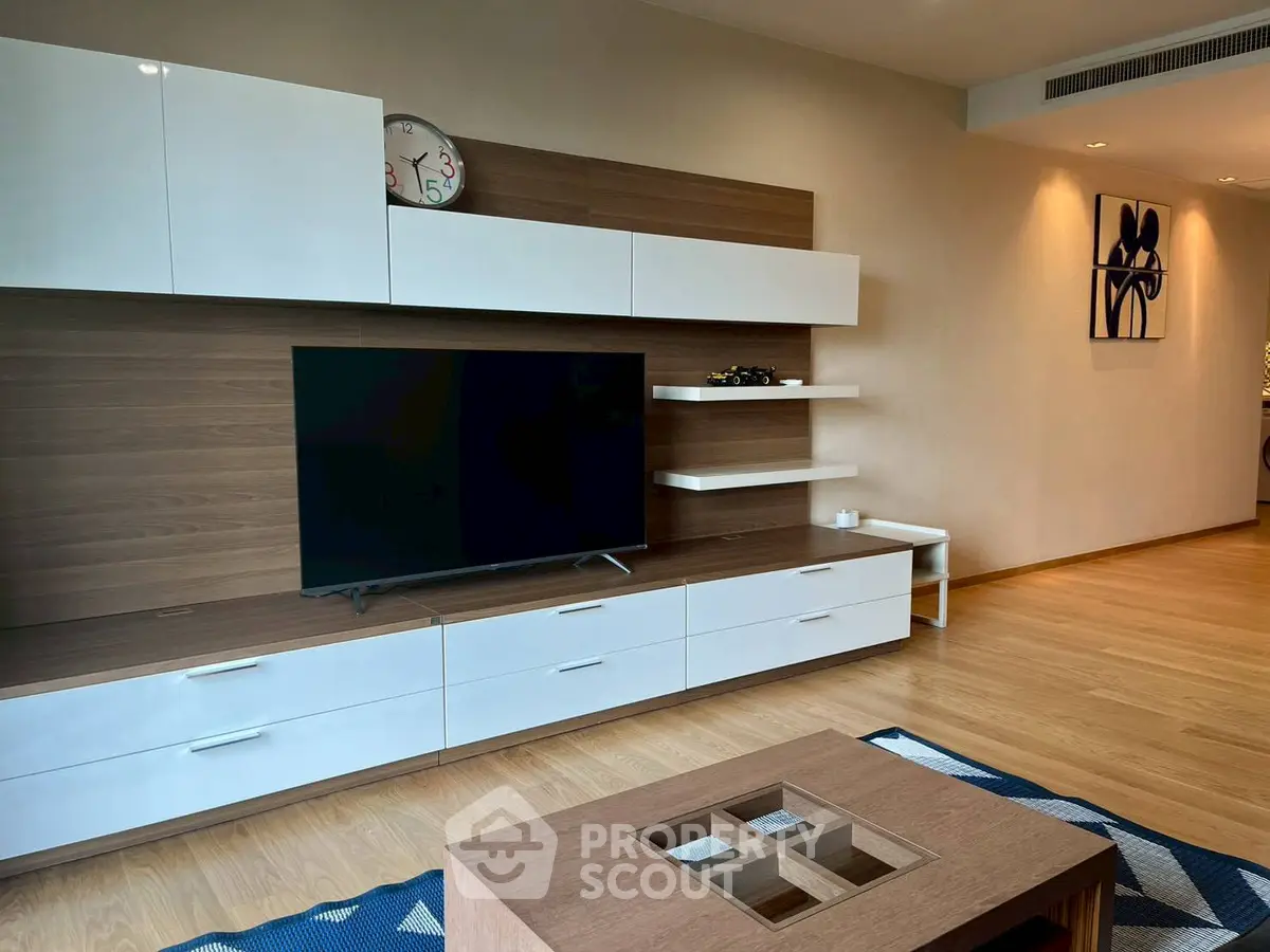 Modern living room with sleek wooden furniture and wall-mounted TV, perfect for stylish urban living.