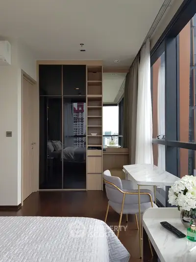 Elegant bedroom with floor-to-ceiling windows and modern decor in a high-rise apartment.