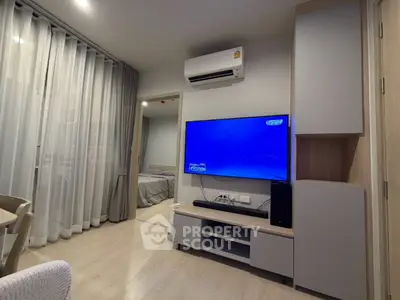 Modern living room with sleek TV setup and cozy bedroom view